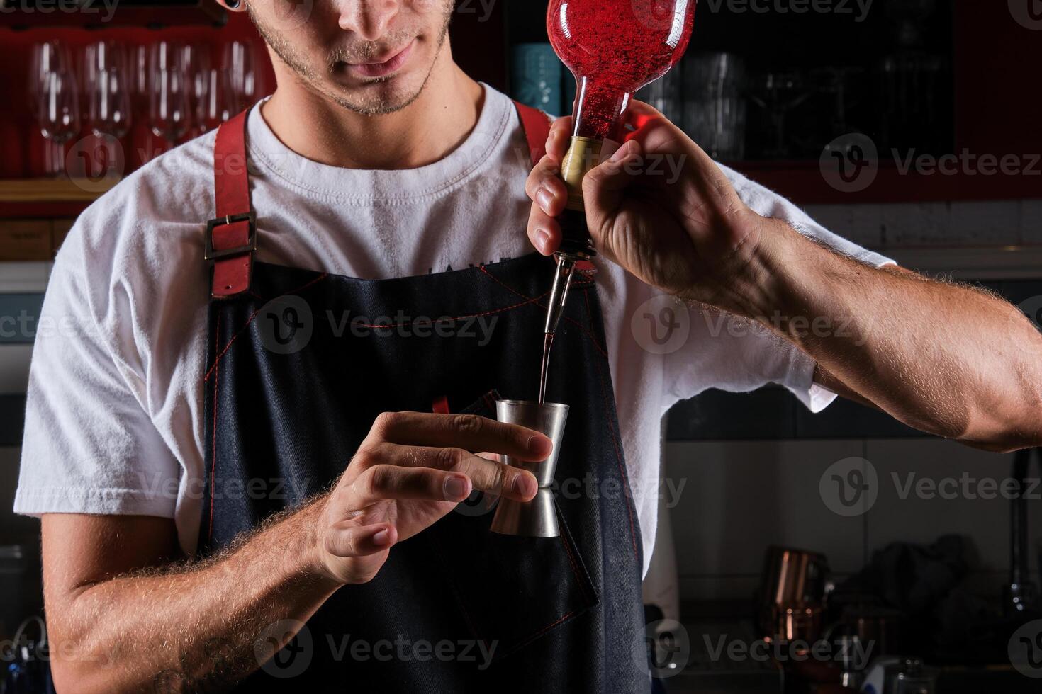 Crop man mixing drink in bar photo