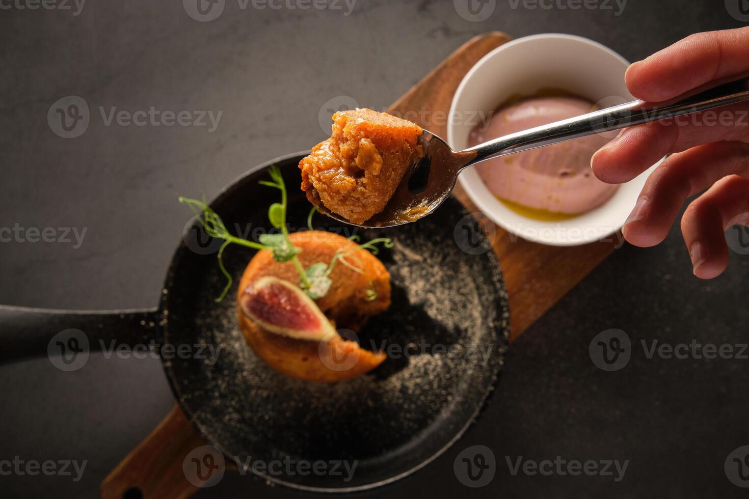Anonymous person eating pie served on chopping board photo