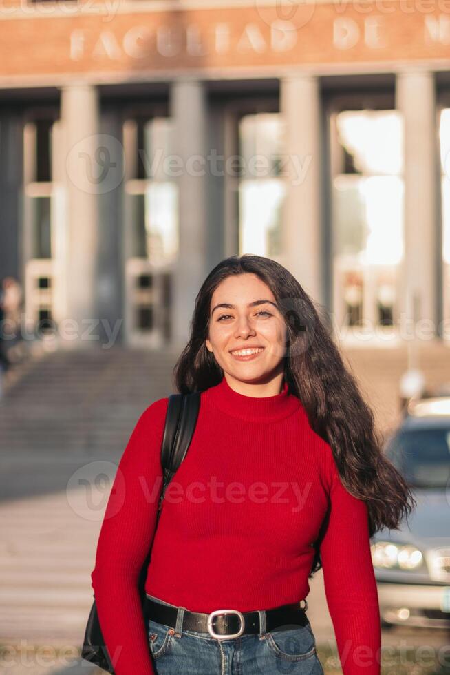 Student woman portrait smiling and posing while looking at the camera photo