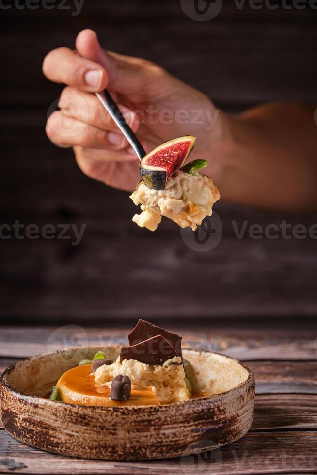 Crop person eating cheesecake with spoon photo