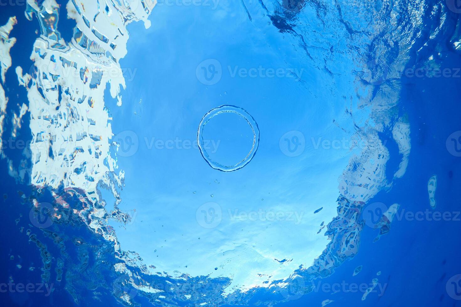 Blue clear water with air ring photo