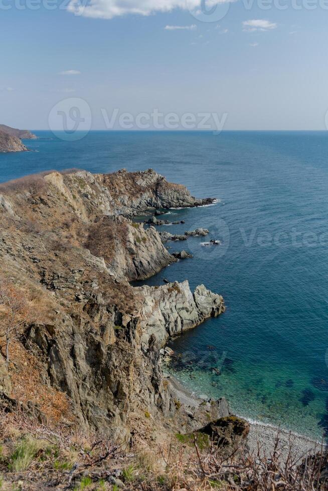 View of the vastness of the Pacific Ocean from the high seashore. High cliffs photo