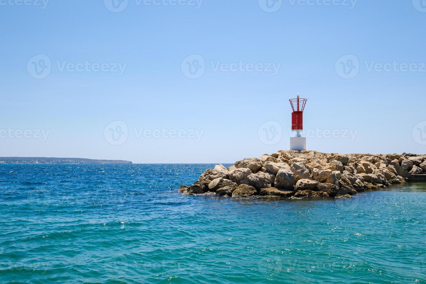 Small lighthouse on seashore photo