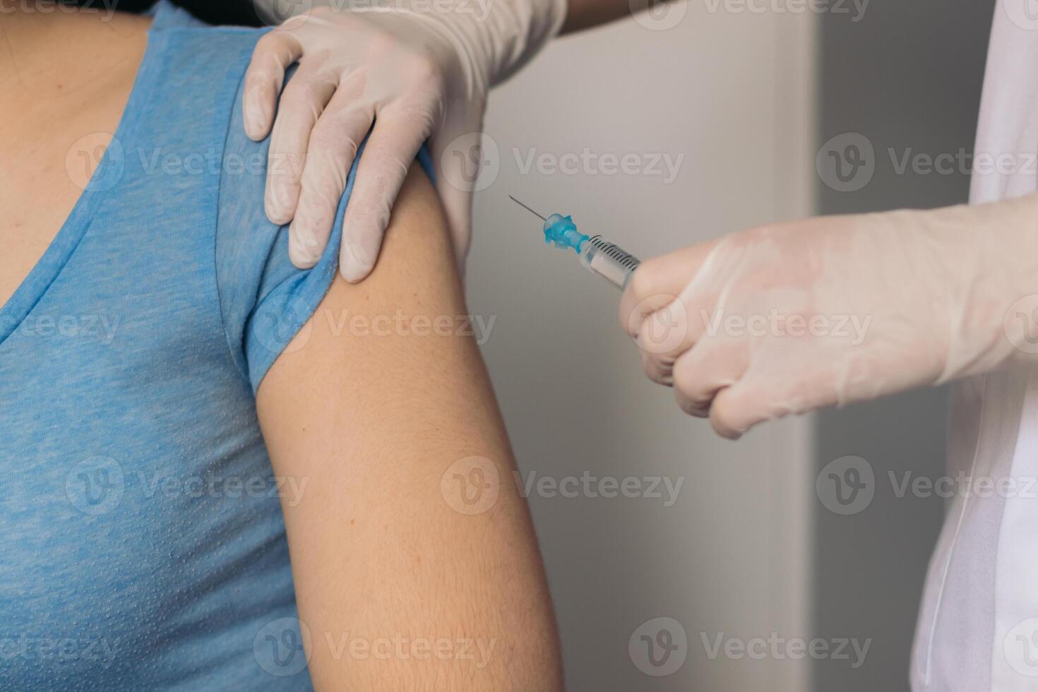 nurse giving a vaccine to a patient. photo