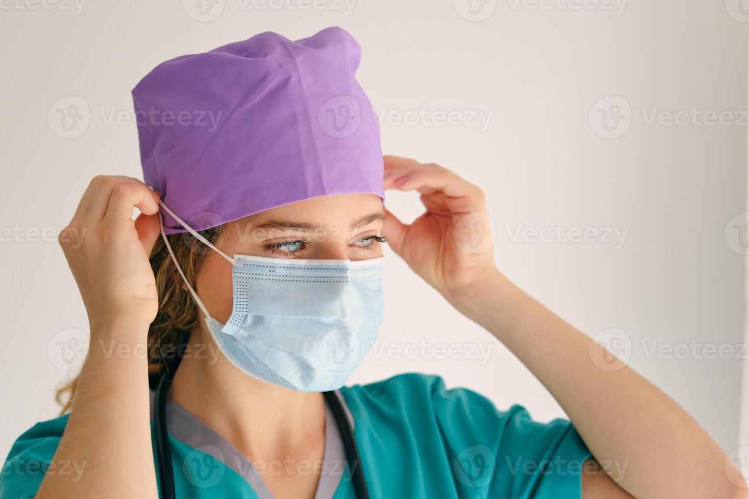 Young woman in scrubs with mask photo