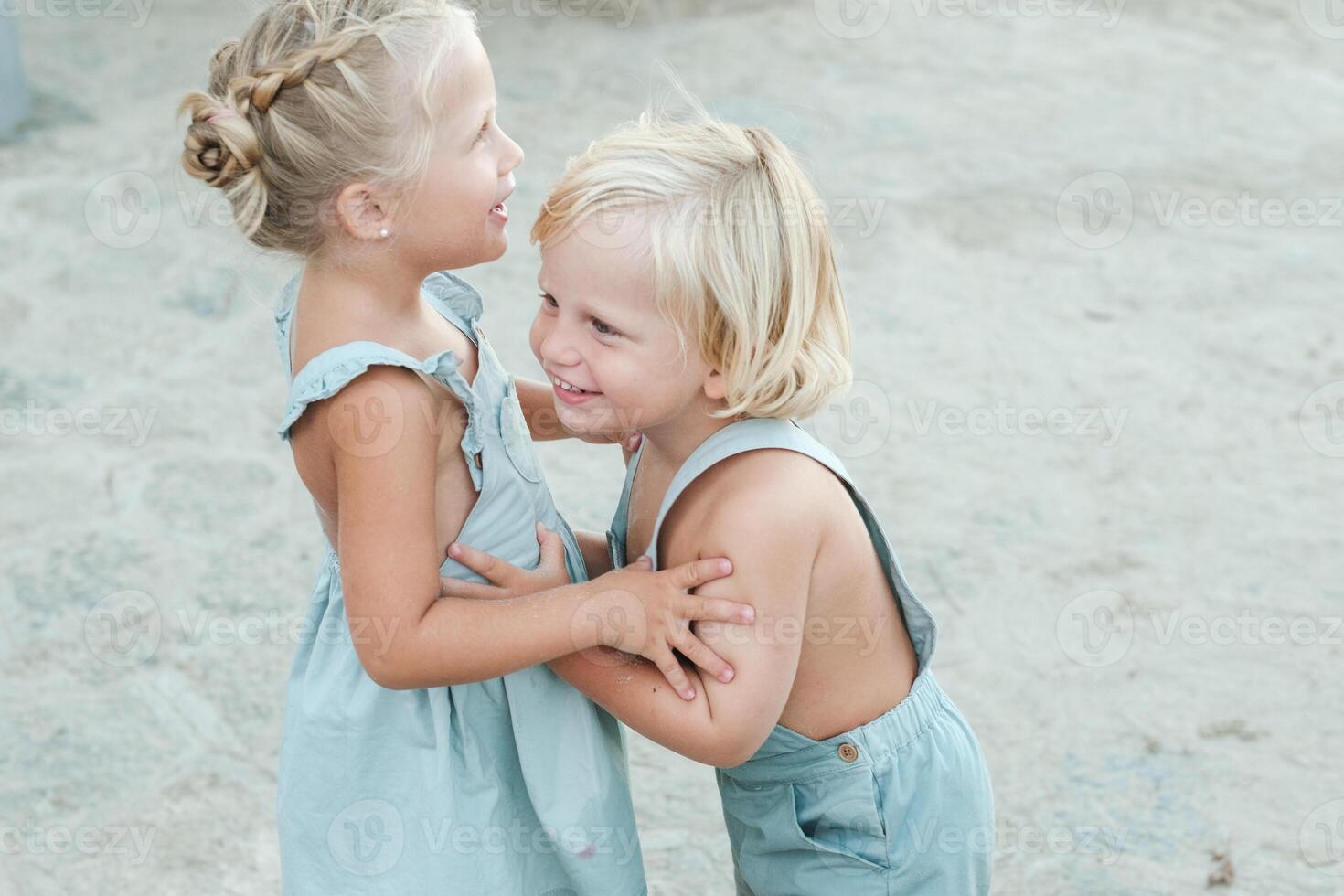 Cheerful children playing on beach photo