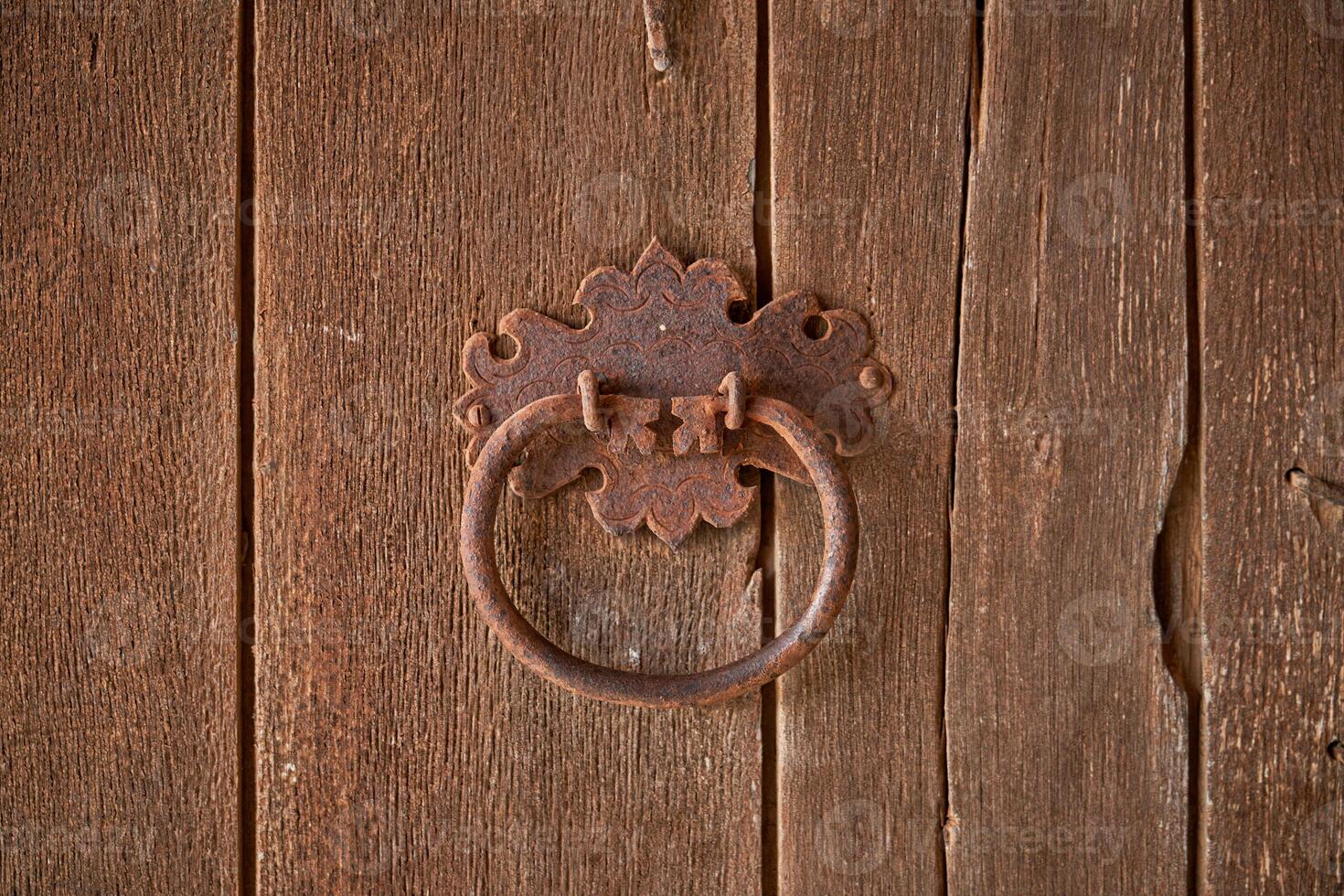 Metal old handle on wooden door photo