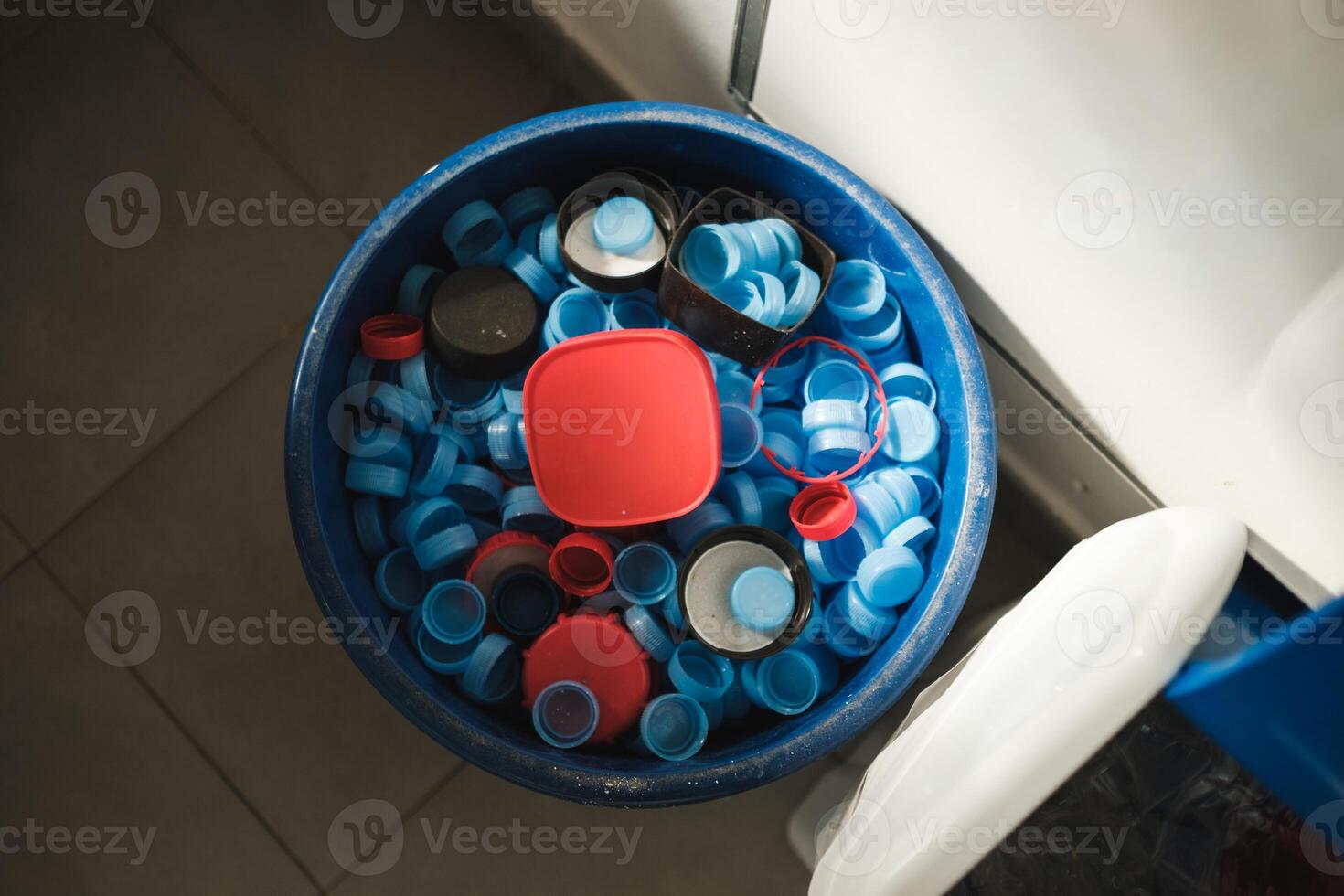 Plastic bucket with bottle caps and container photo