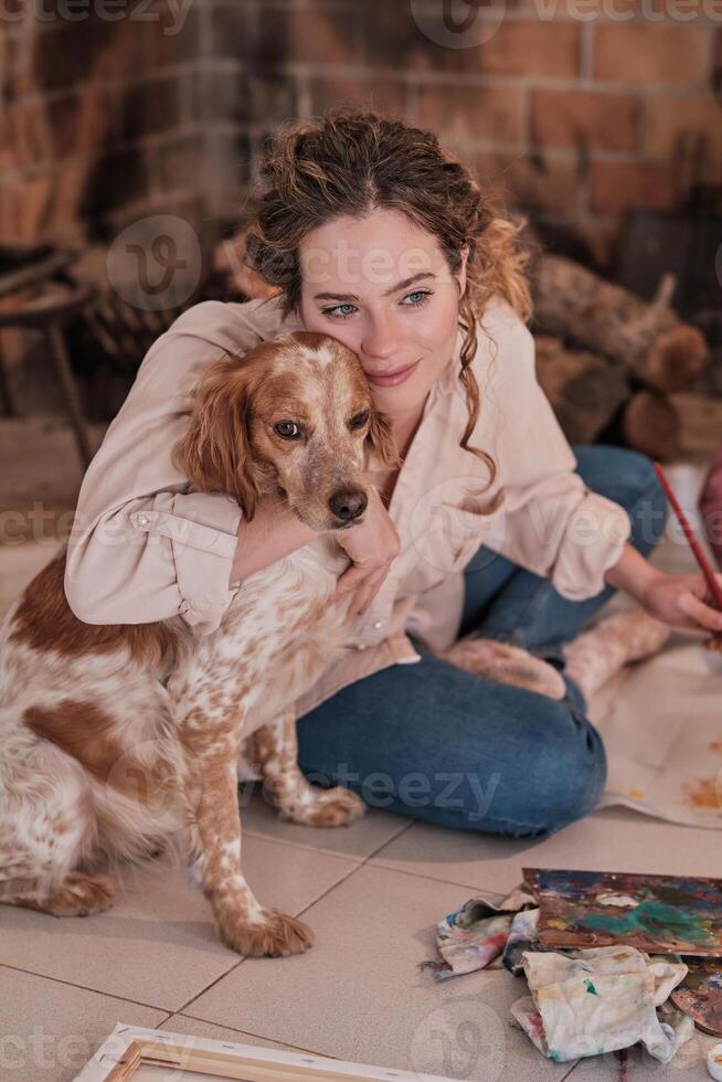 Woman with dog painting at home photo