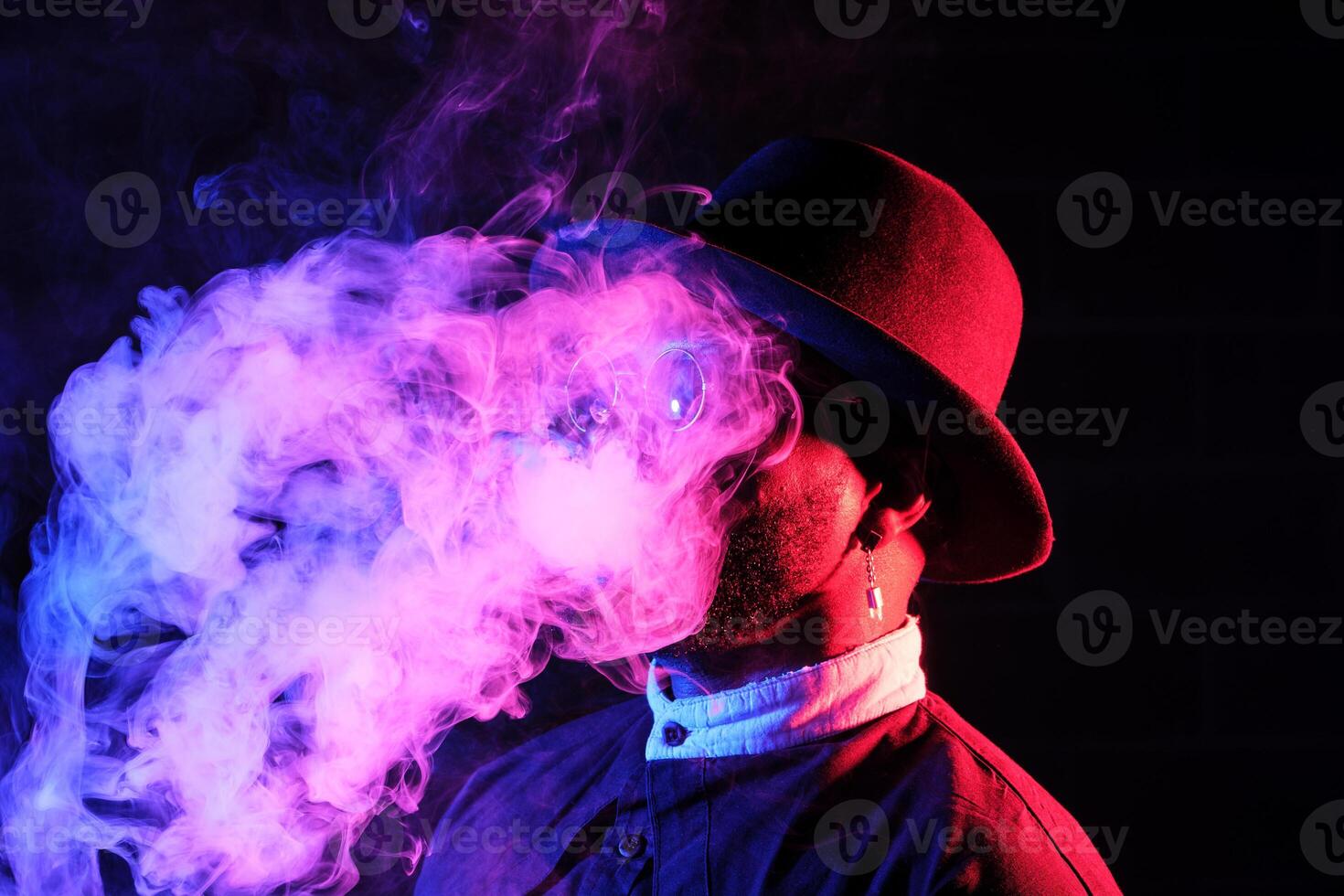 Stylish man with smoke in neon photo
