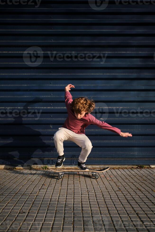 Energetic boy riding skateboard on sidewalk photo