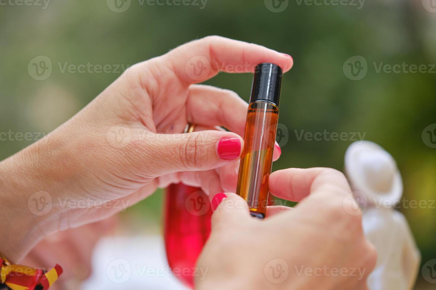 Crop woman with bottle of cosmetic oil photo