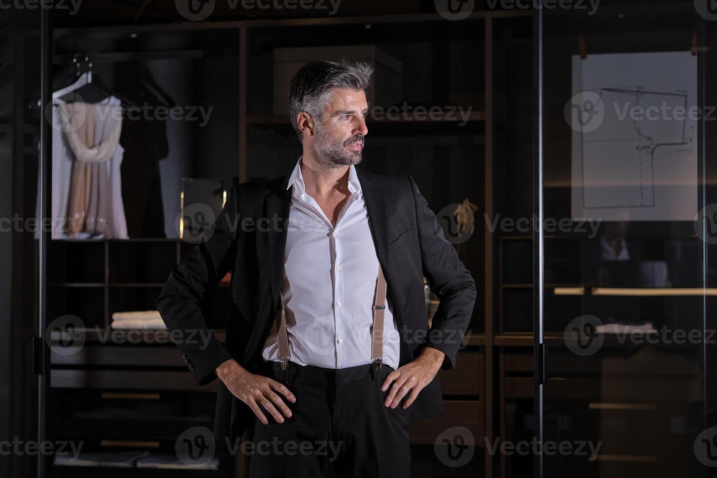 Mature businessman in suit standing at home photo