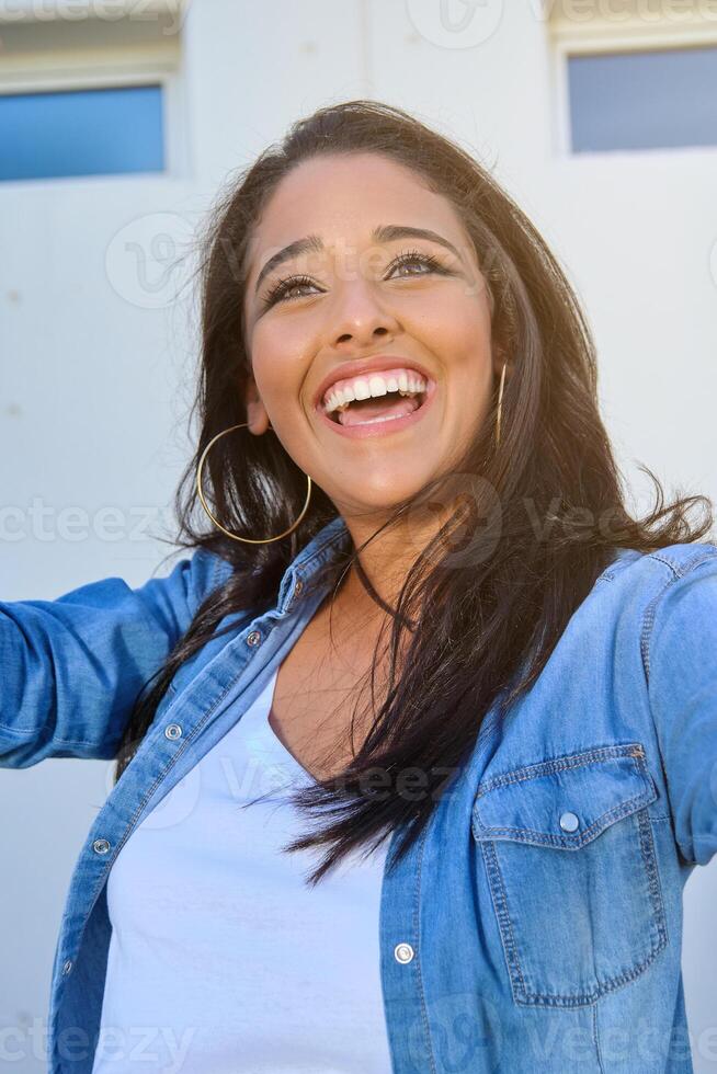 Cheerful young woman smiling and looking away photo