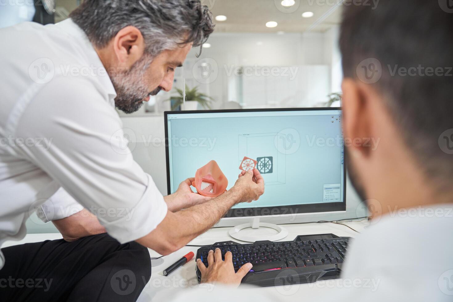 Engineers with 3D model of respirator near computer photo