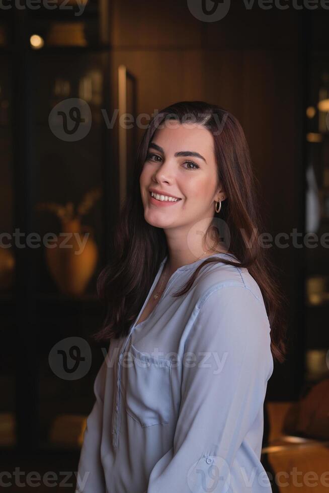 Smiling young woman in living room photo