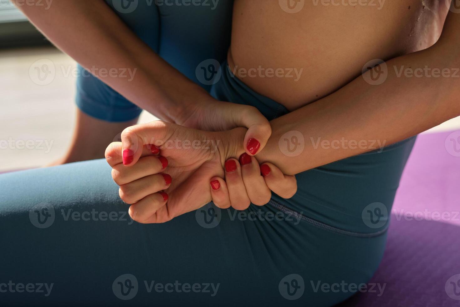 Woman doing Sage Marichis for stretching spine photo