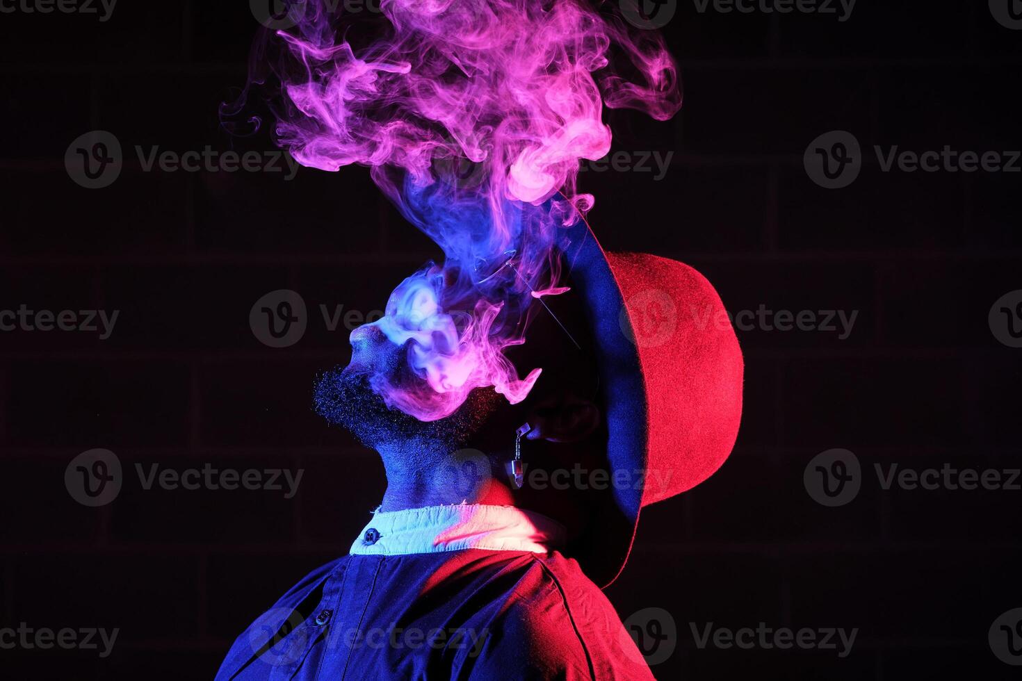 Black man with smoke in neon light photo