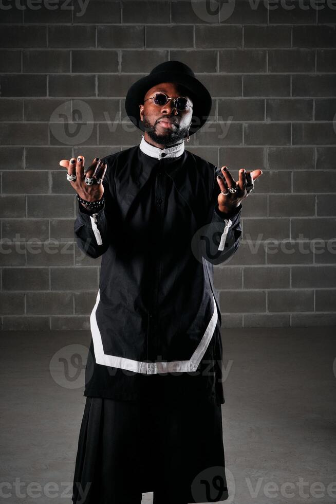 Man wearing black outfit looking at camera photo