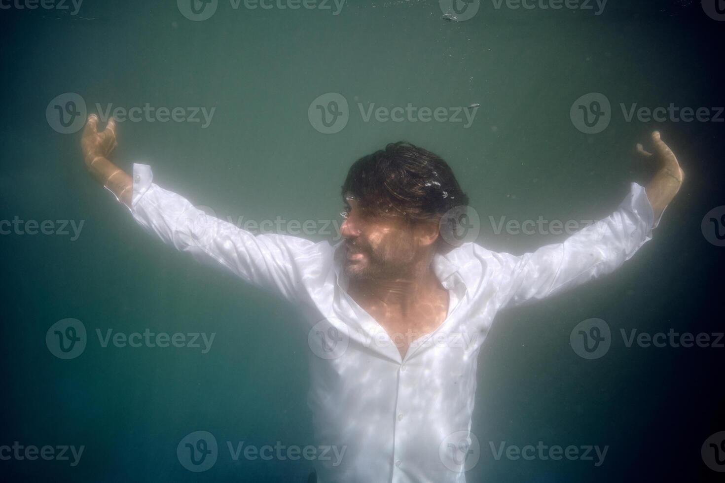 Man drowning in deep blue water photo