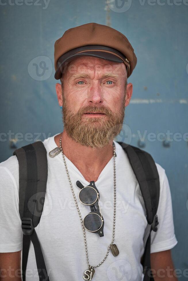 Serious mature traveling man in stylish cap photo