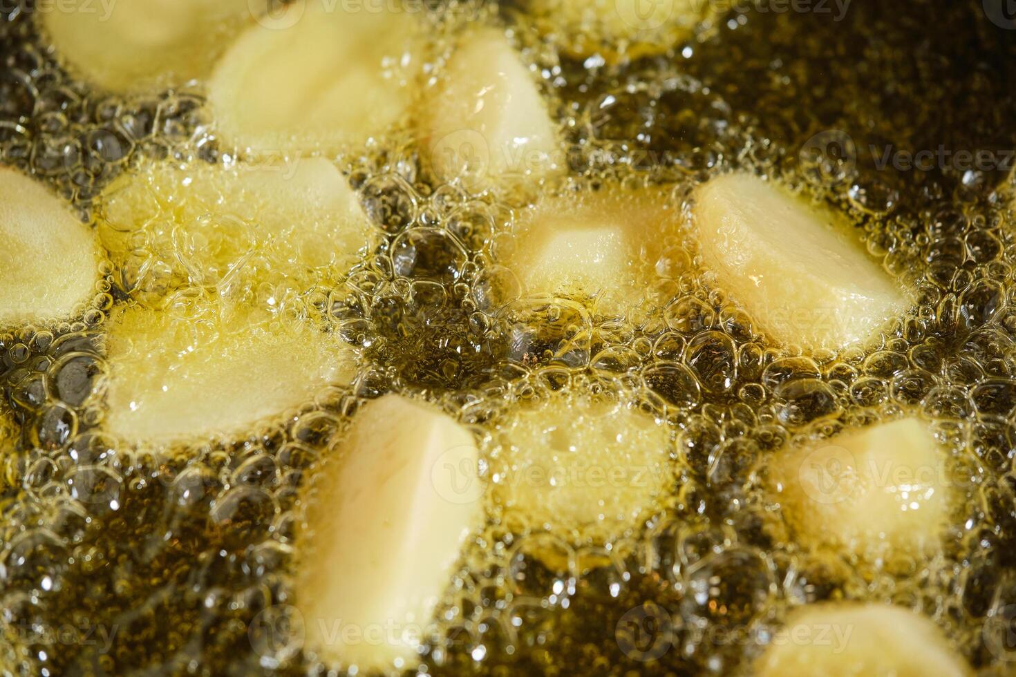 Closeup of potato in boiling oil photo