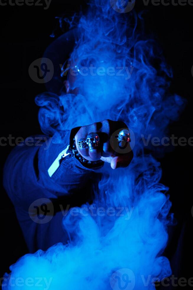 Unrecognizable man punching through vapor photo