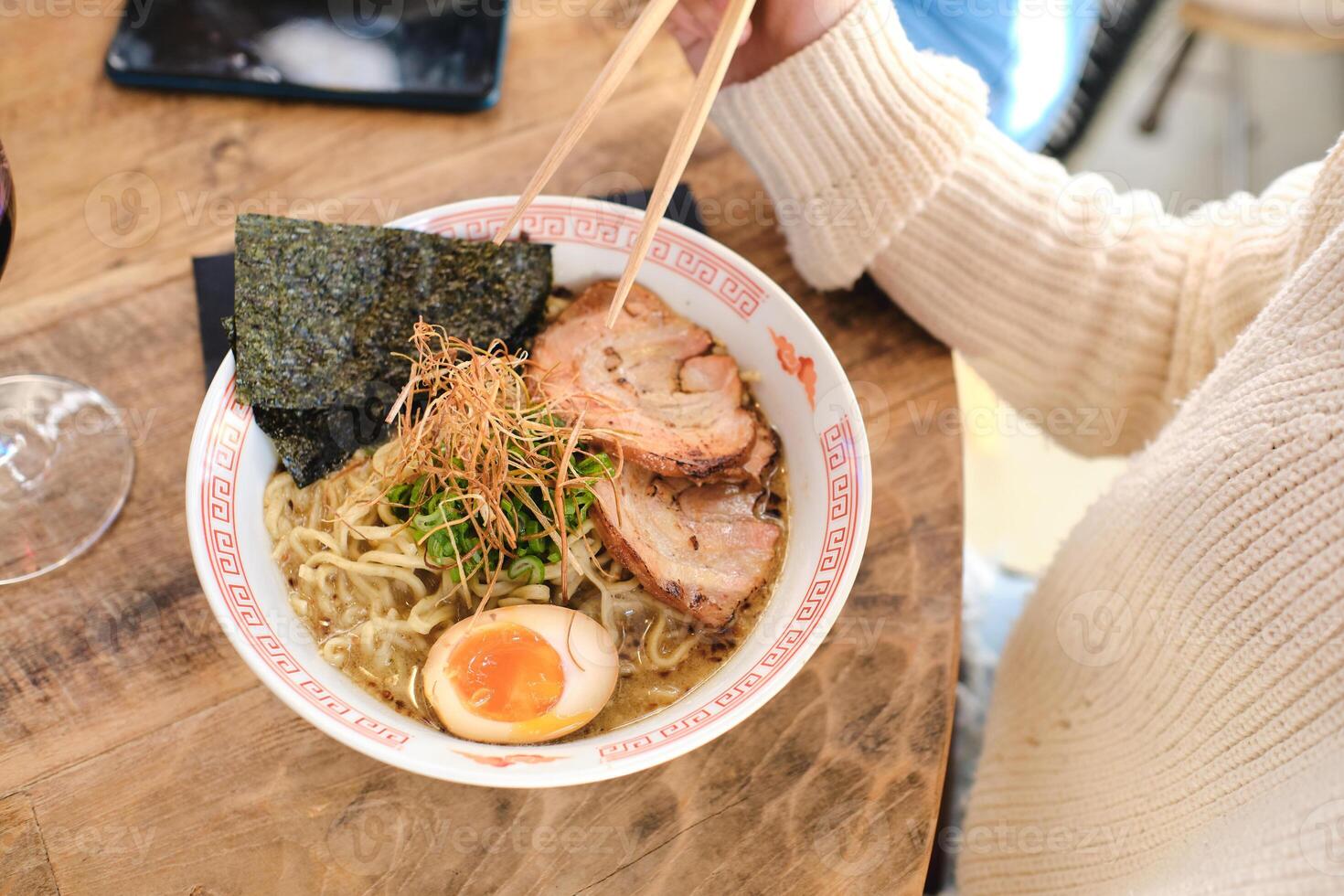 Faceless person eating delicious asian noodles photo