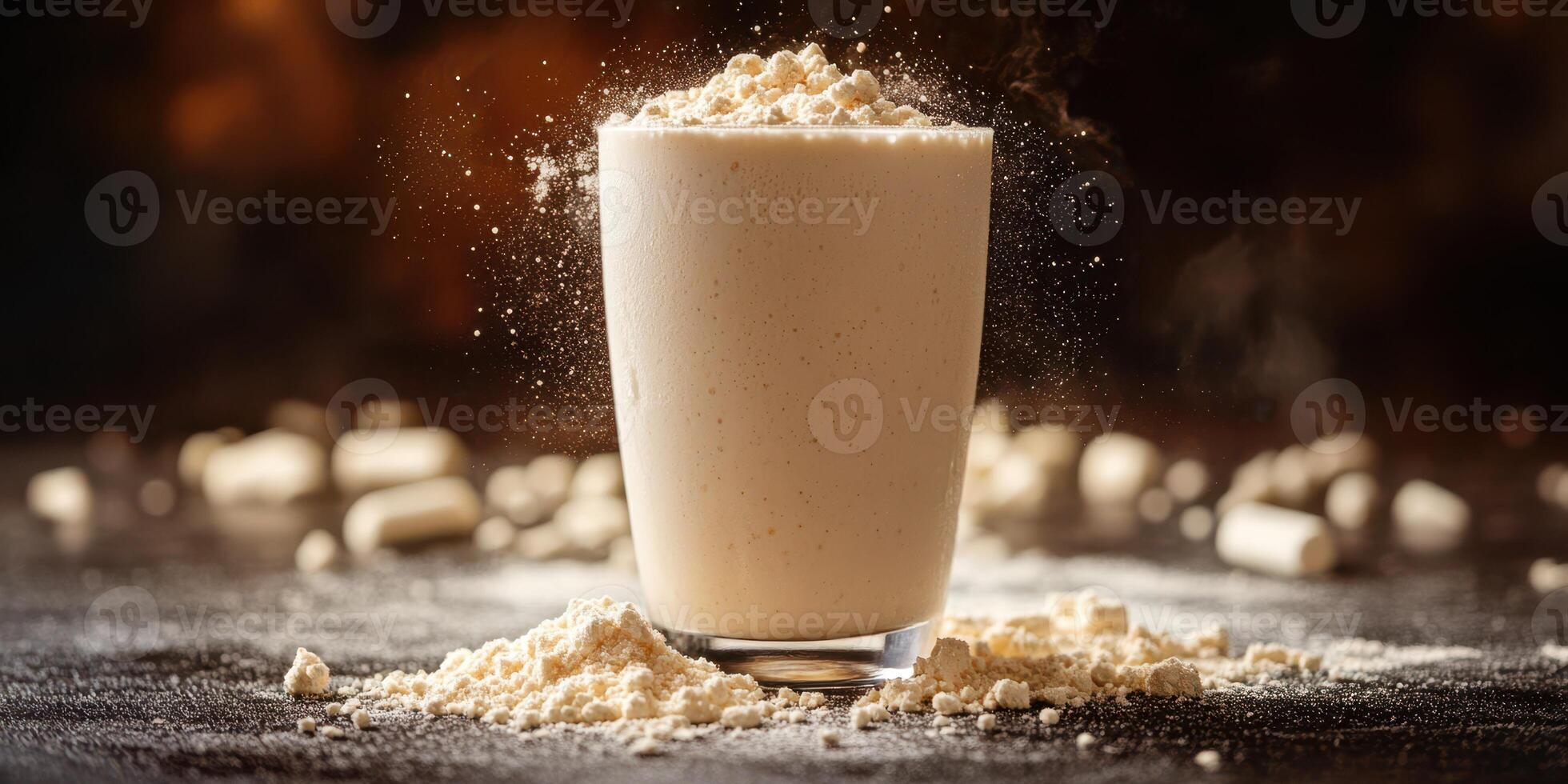 Creamy protein shake surrounded by protein powder on a dark surface captured in a cozy kitchen setting during evening light photo
