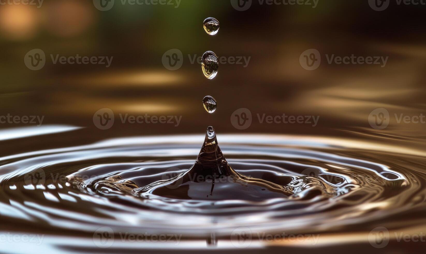 A drop of water is falling into a body of water photo