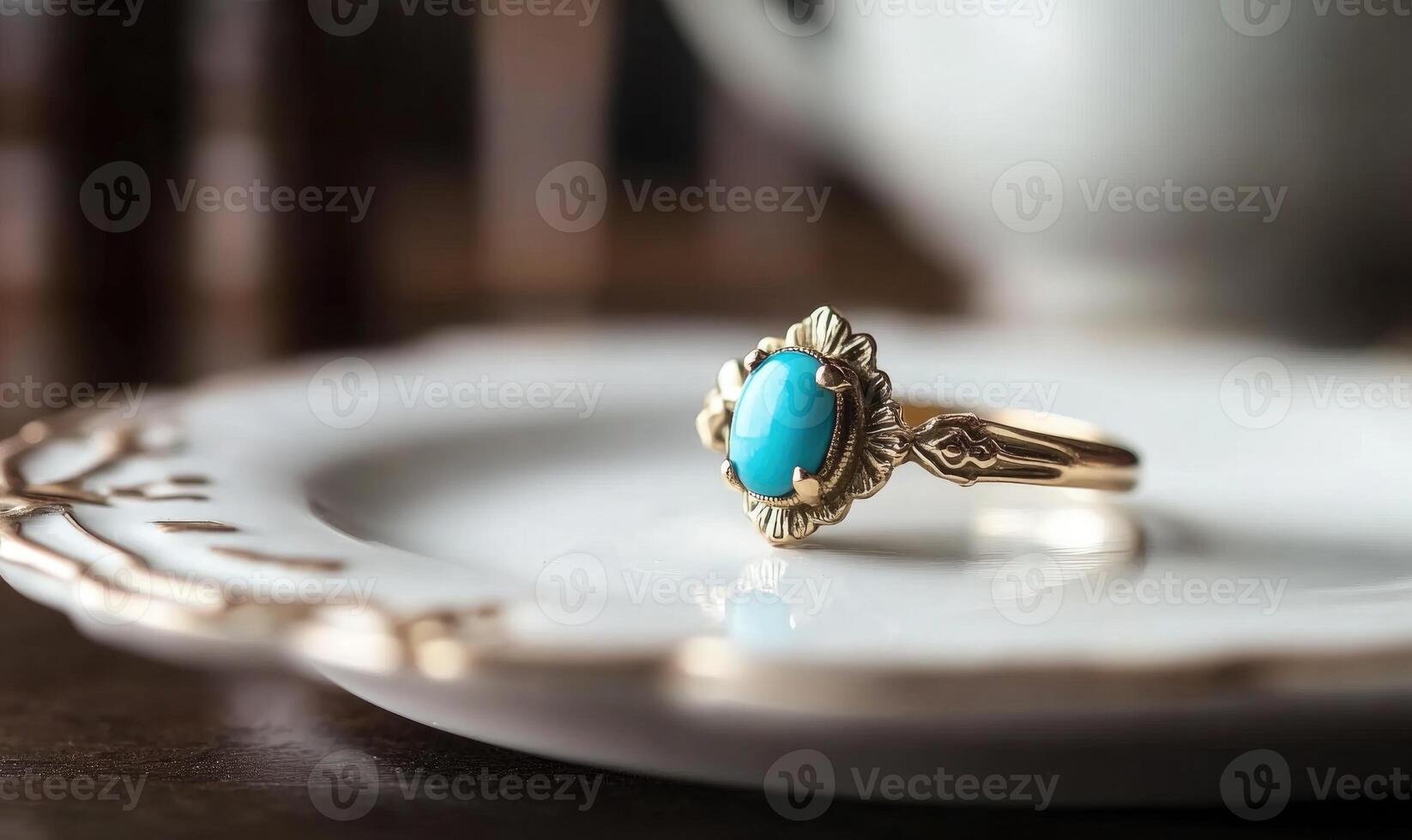 A gold and blue ring is on a white plate photo