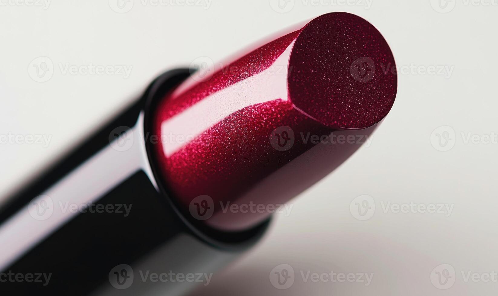 a close up of a red lipstick on a white surface photo