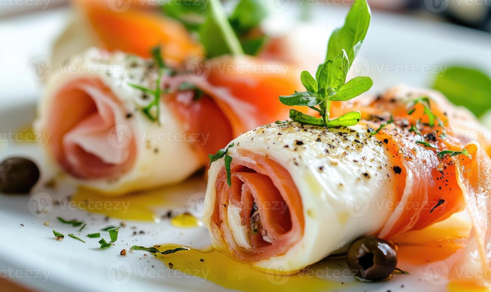 A plate of food with two pieces of ham and a green leaf on top photo