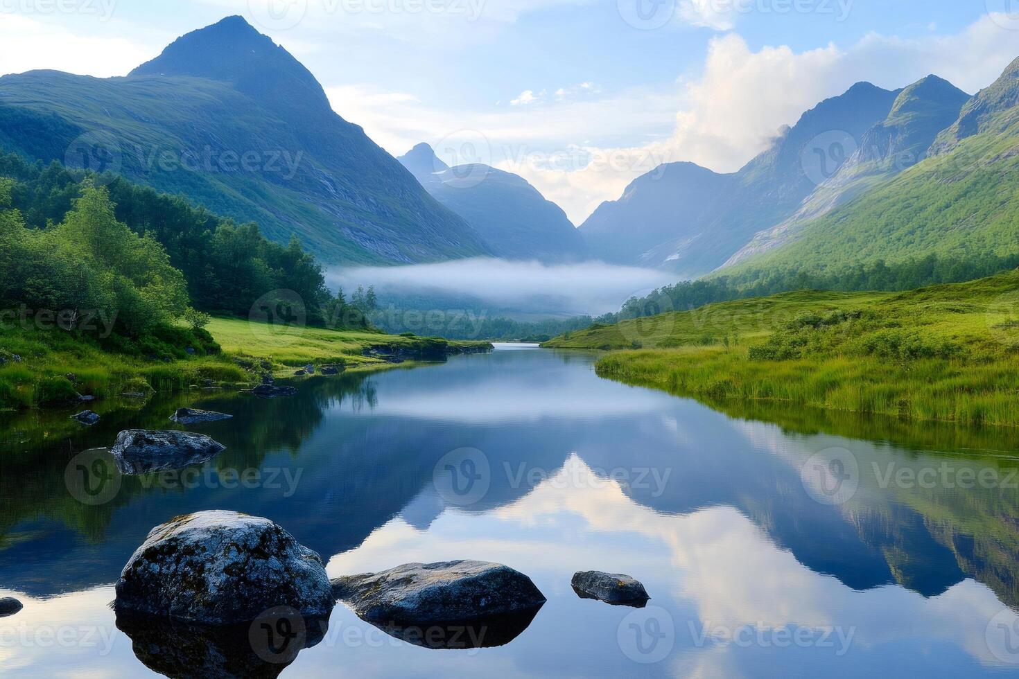 Fog rolling over a pristine lake reflecting mountains in Norway photo