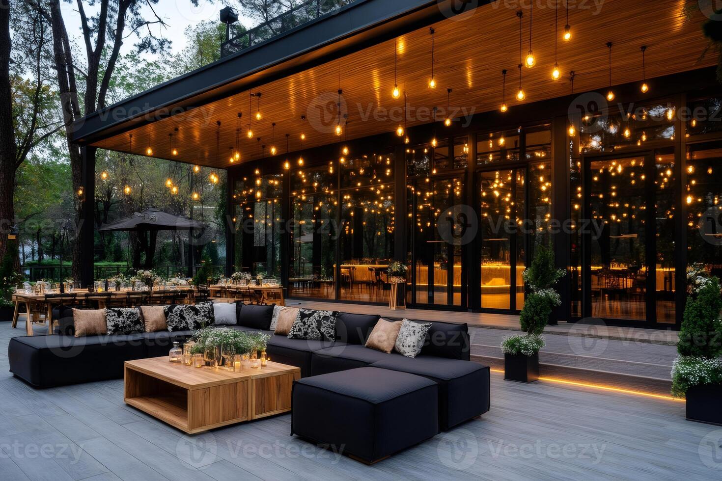 Modern restaurant terrace with hanging lights illuminating outdoor lounge area photo