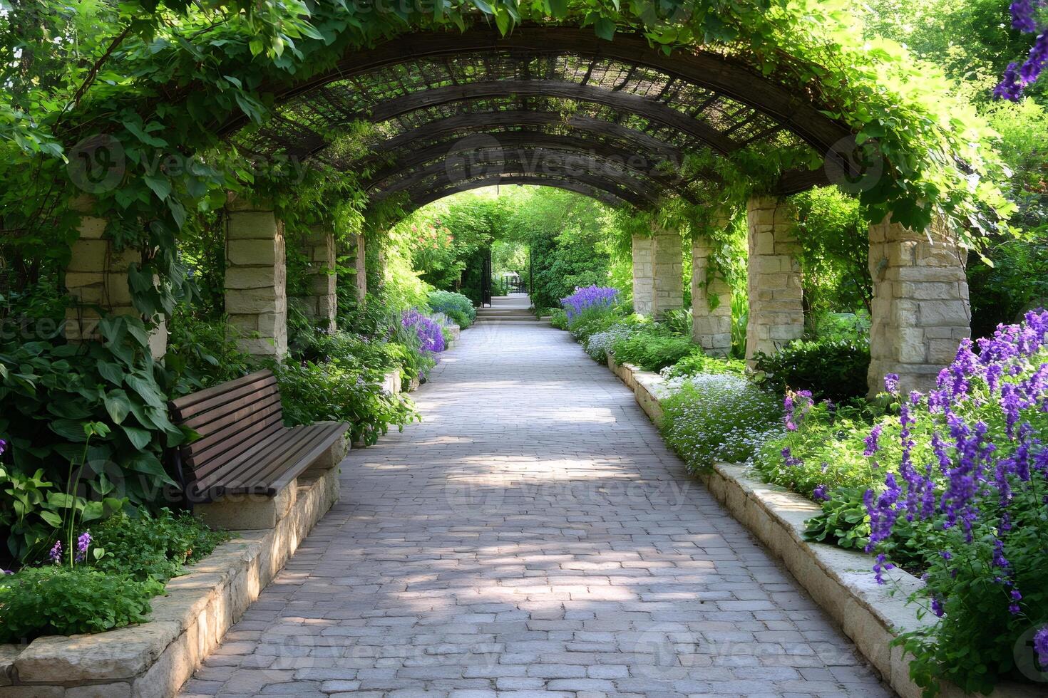 Beautiful pergola covering a paved path in a garden with purple flowers photo