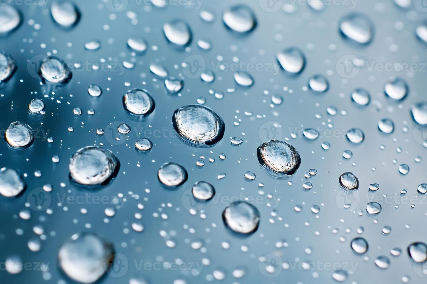 Close-up of water droplets reflecting light on a smooth surface photo
