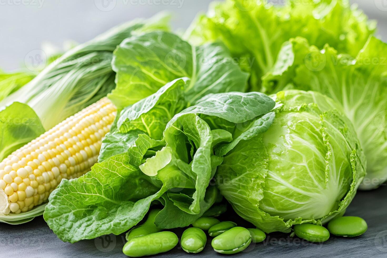Fresh green vegetables and corn cob creating a healthy vegetarian still life photo