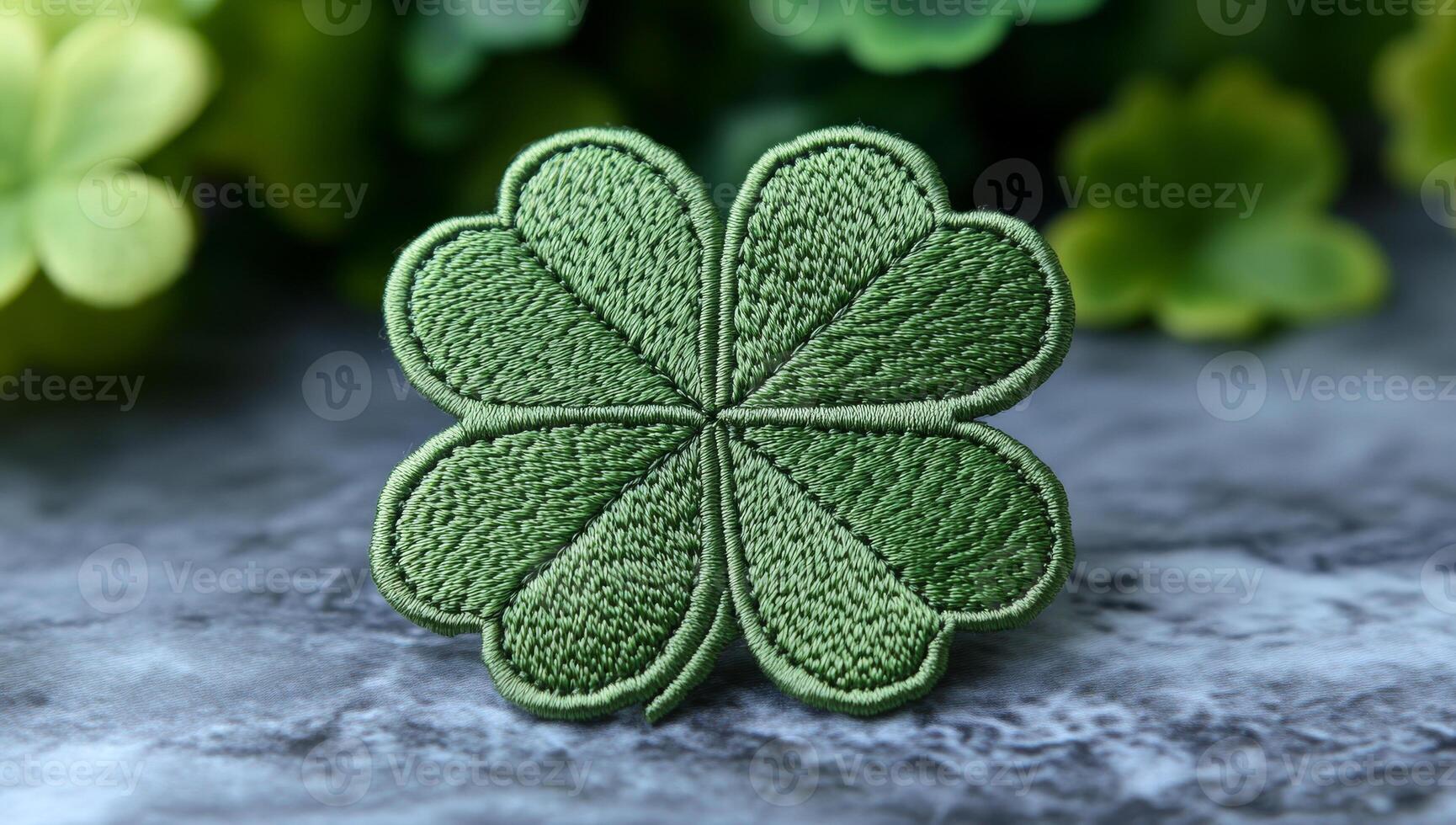 Embroidered green four-leaf clover patch. A green four-leaf clover is on a textured surface, surrounded by blurred foliage, symbolizing good luck. photo