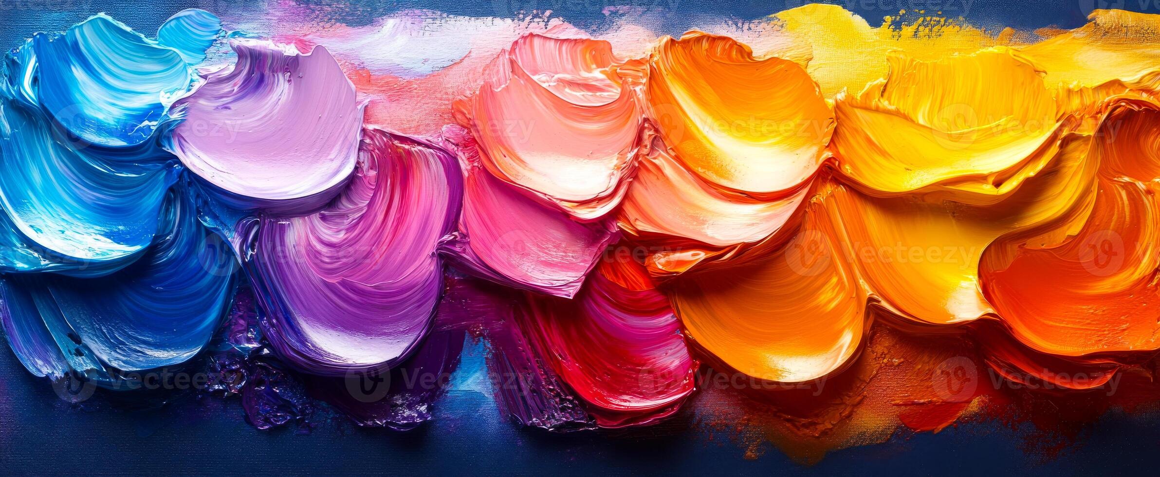 Colorful abstract paint swirl on canvas. Swirls of purple, pink, orange, and yellow form an abstract design on a deep blue background. photo