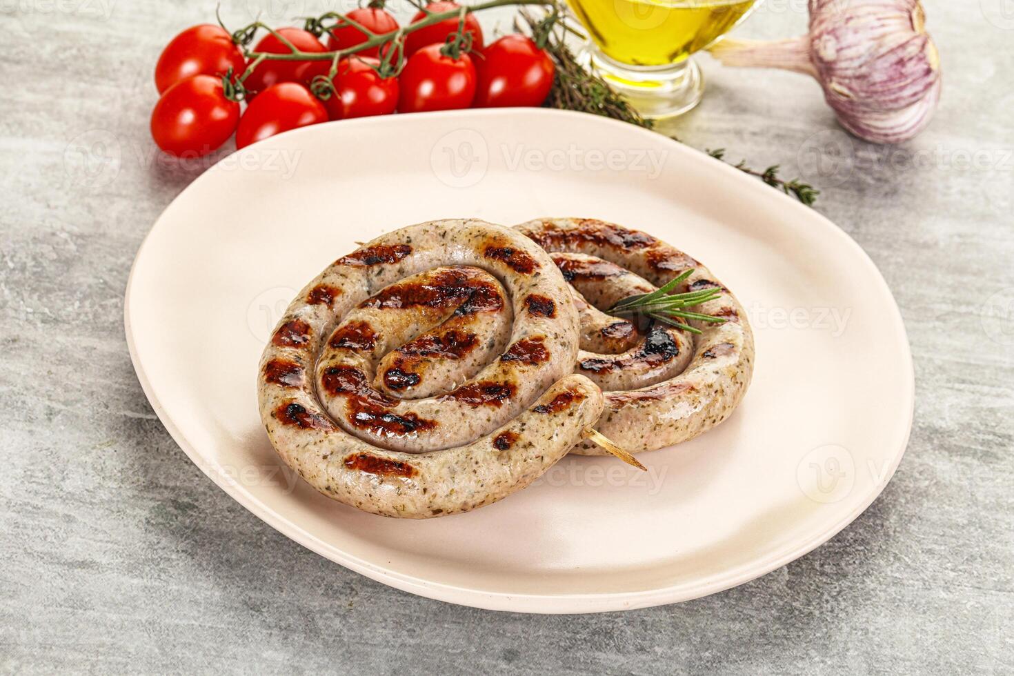 A plate with two grilled sausages on it photo