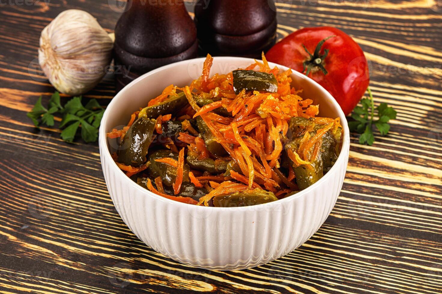 A white bowl filled with vegetables and a bottle of ketchup photo