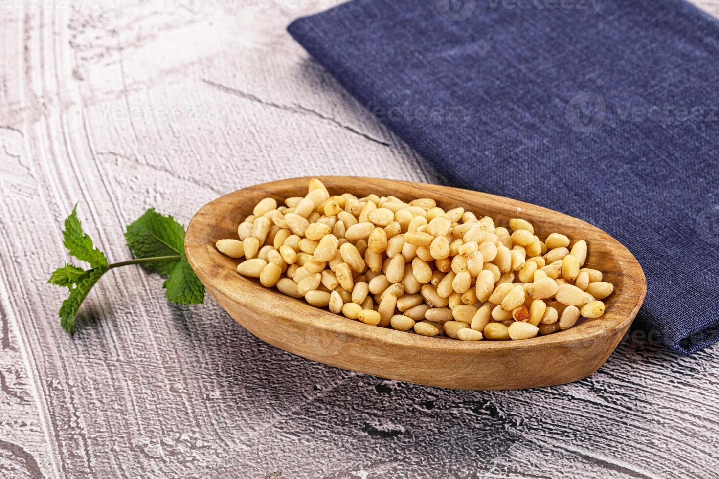 A wooden bowl filled with dried beans and a napkin photo