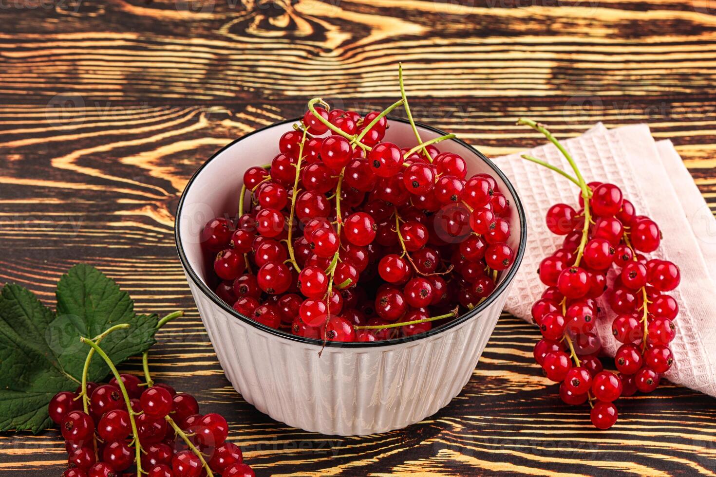 A bowl of red currants on a table photo