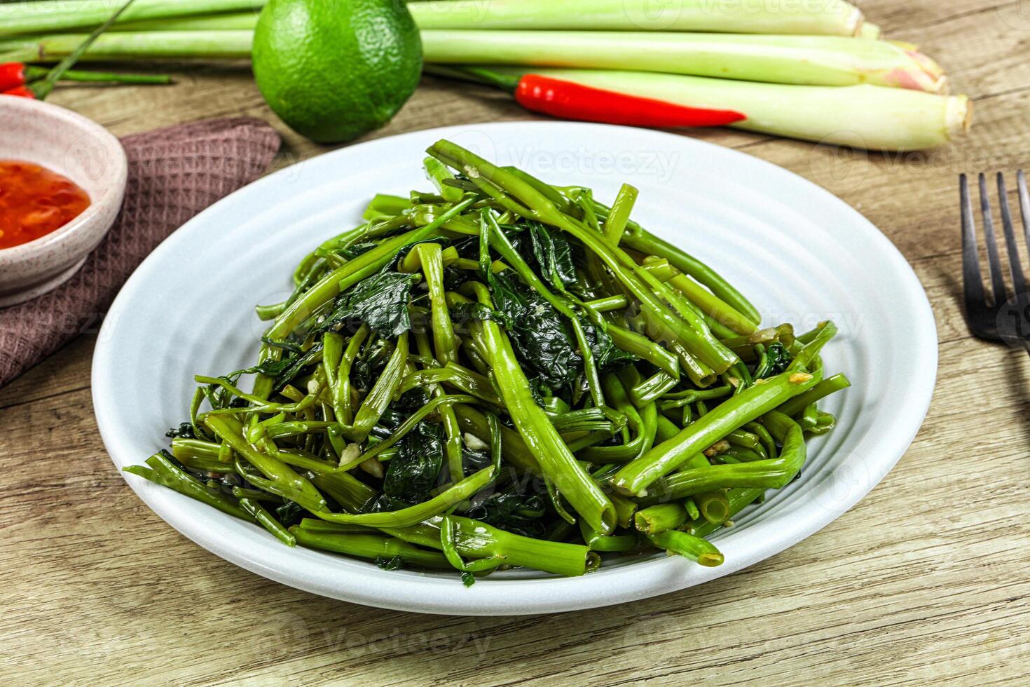 A bowl of green beans and a bowl of chili peppers photo