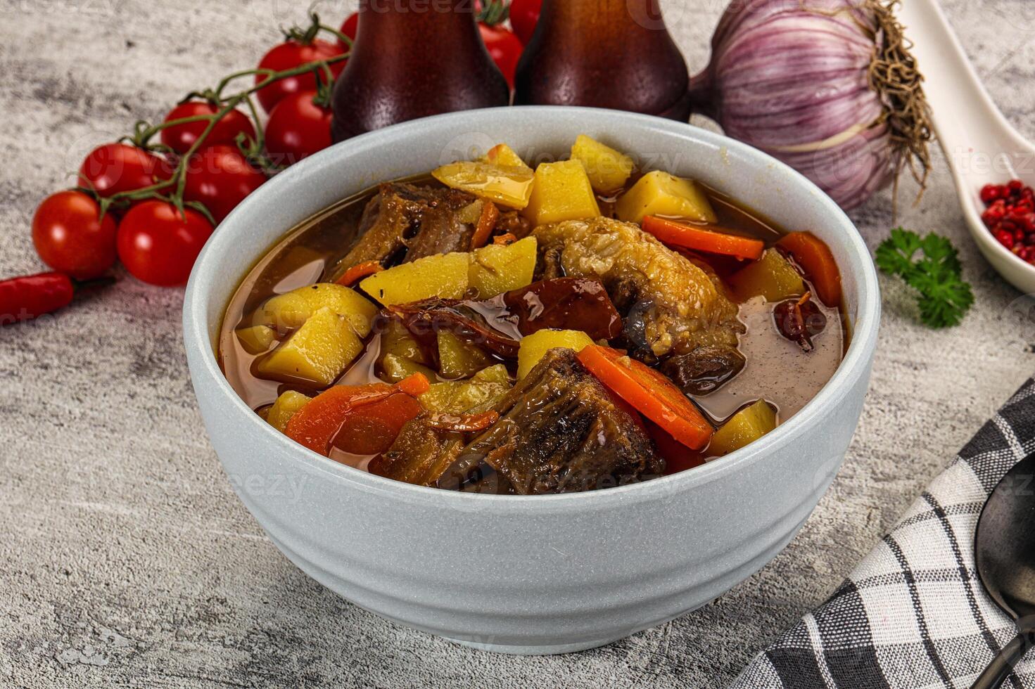 A bowl of stew with vegetables and meat in it photo