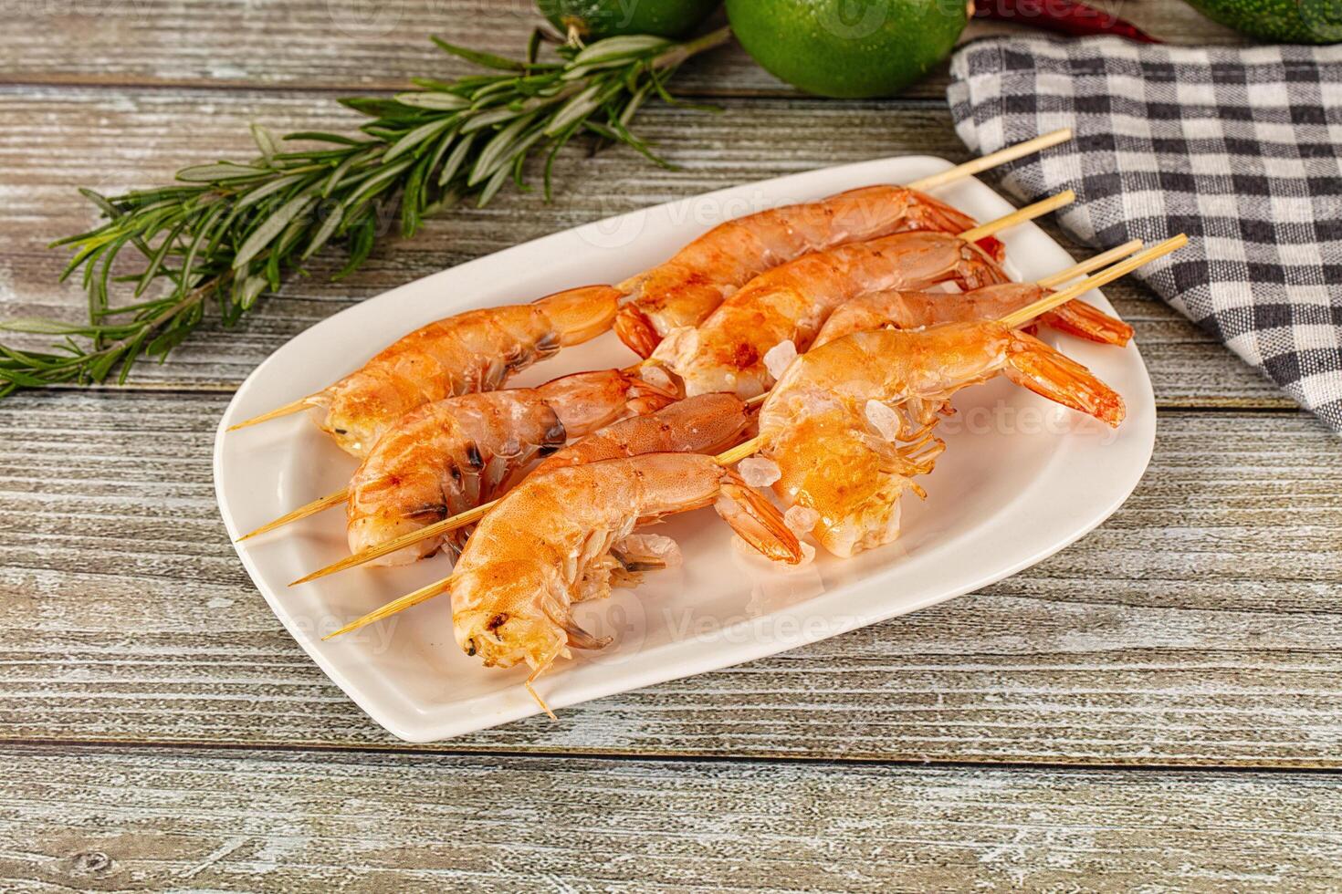 Grilled shrimp on skewers on a plate photo