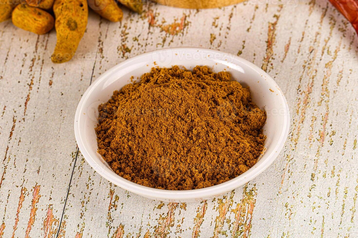 A bowl of spices and a bowl of chili peppers photo