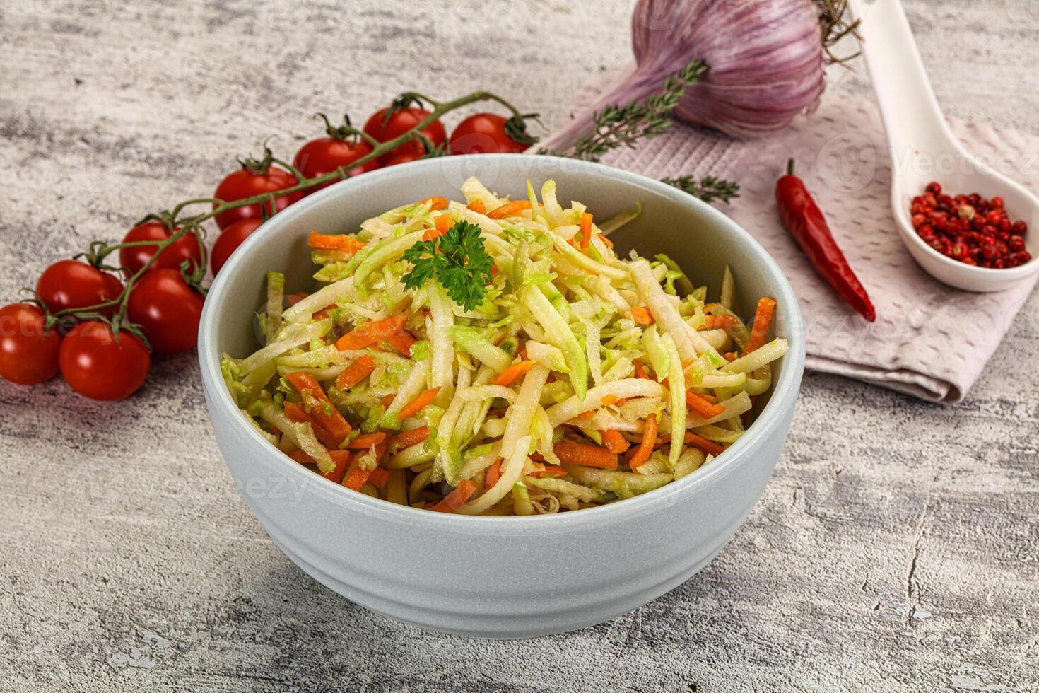A bowl of coleslaw with tomatoes and onions photo