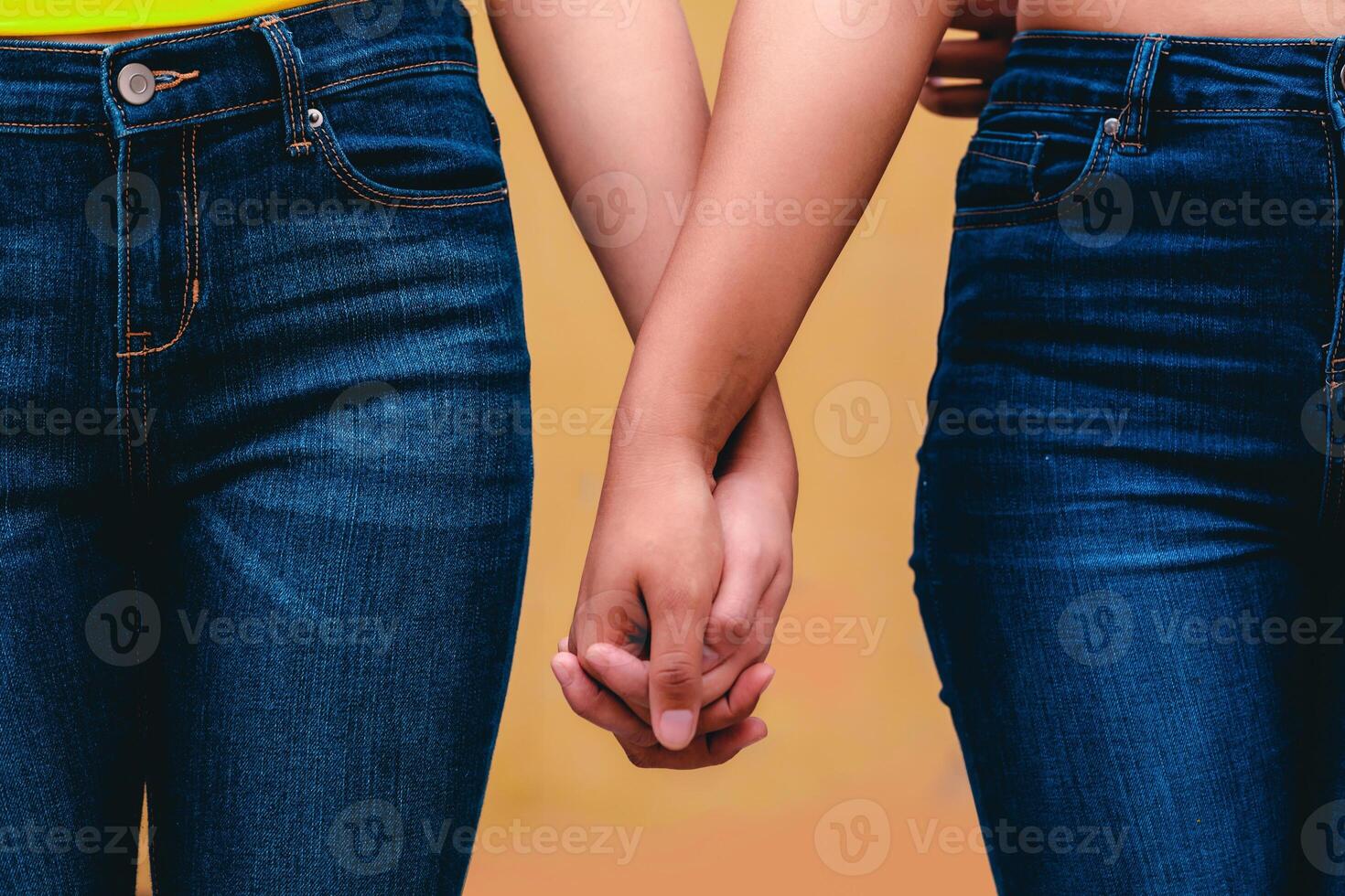 close up of two unrecognized women hands together, diversity, lesbian love concept. photo